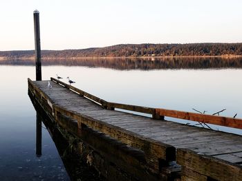 Pier on water against sky