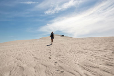 Rear view of man on sand dune