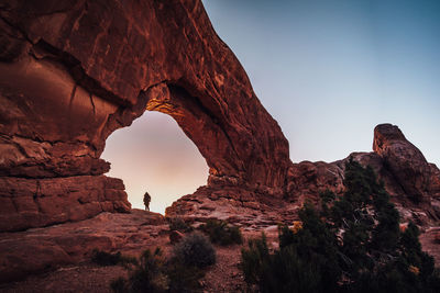 Low angle view of rock formation in desert against sky at sunset