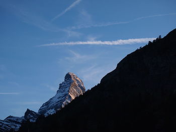 Low angle view of rocky mountains against sky