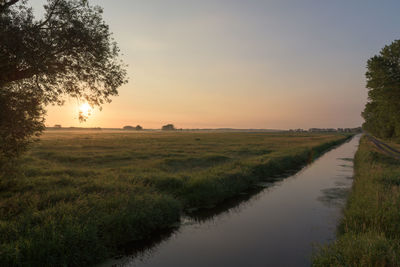 Scenic view of field against sky during sunset