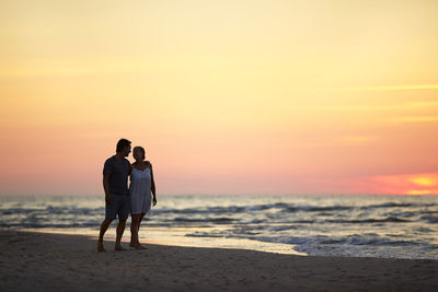 Couple on beach at sunset