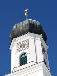 Low angle view of statue against blue sky