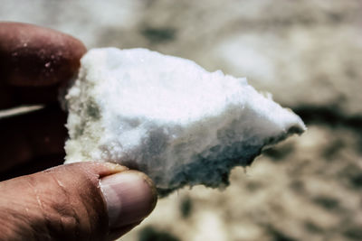 Close-up of hand holding ice