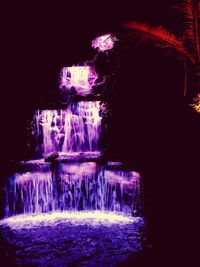 Illuminated fountain at night