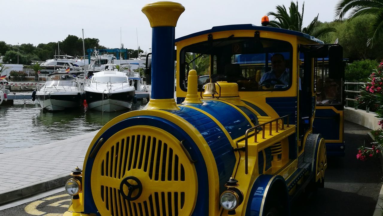 CLOSE-UP OF YELLOW SHIP MOORED AT SHORE