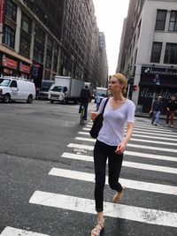 Rear view of woman standing on city street