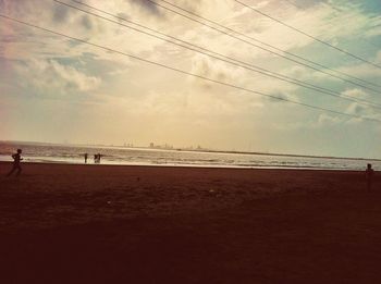 Scenic view of beach against sky during sunset