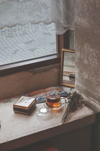 High angle view of glass on table by window in building