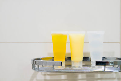 Close-up of drink on table against wall