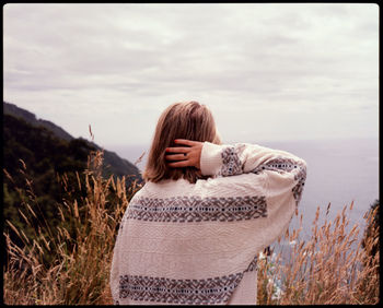 Rear view of woman standing against sky