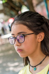 Close-up of thoughtful girl wearing sunglasses