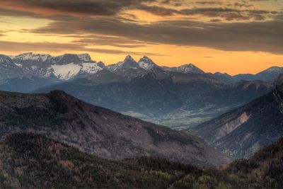 Scenic view of mountains against cloudy sky