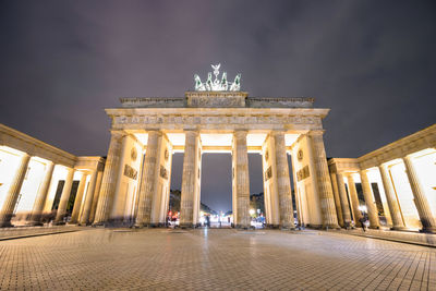 Low angle view of illuminated historical building at night