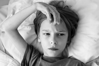 Portrait of boy lying on bed