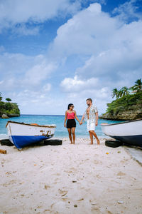 People on beach against sky