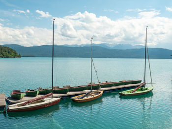 Pier with rental row boats and yachts at mountain lake walchensee in bavaria, germany.  holiday land