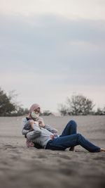 Woman on land against sky