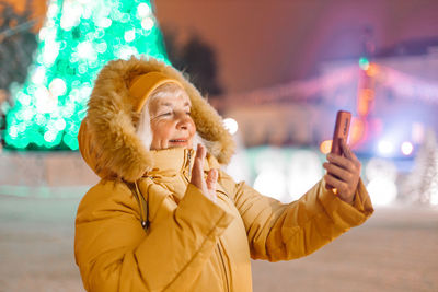 Portrait of young woman using mobile phone