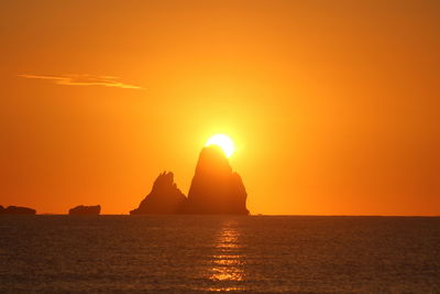 Scenic view of sea against orange sky