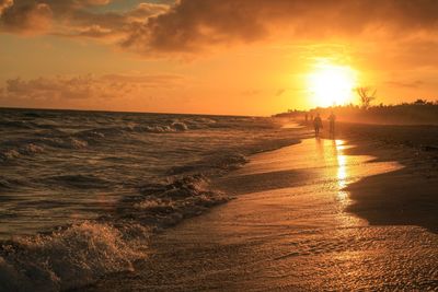 Scenic view of beach against sky during sunset