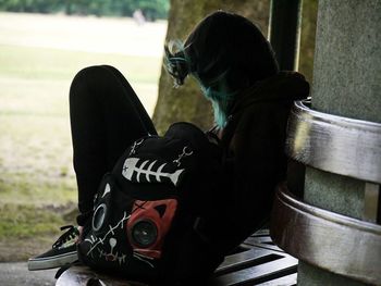 Close-up of woman sitting on bench