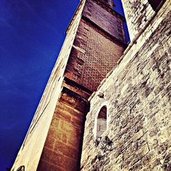 Low angle view of building against blue sky