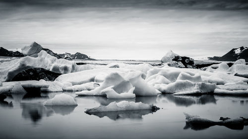 Scenic view of frozen lake against sky