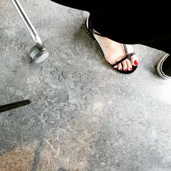 Low section of woman standing on tiled floor
