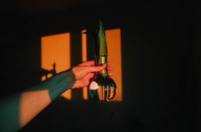 Close-up of hand holding beer glass