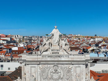 The rua augusta arch in lisbon, portugal. statues and monument