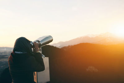 Woman looking through binoculars