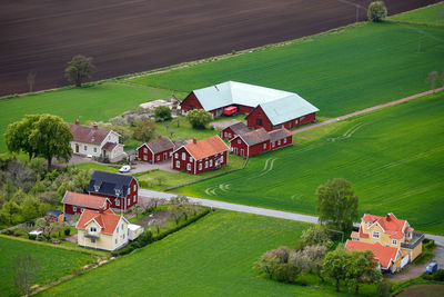 High angle view of houses on field against buildings