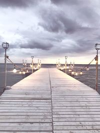 Empty pier on sea against sky