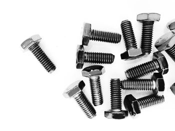 Close-up of nut bolts on white background