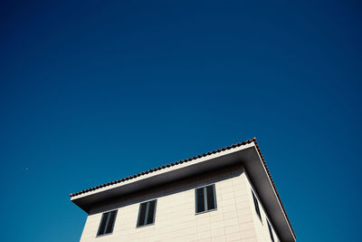 Low angle view of building against blue sky