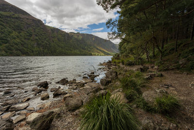 Scenic view of lake and mountains against sky