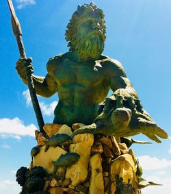 Low angle view of angel statue against clear blue sky