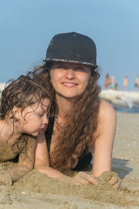 Portrait of smiling girl on beach against sky