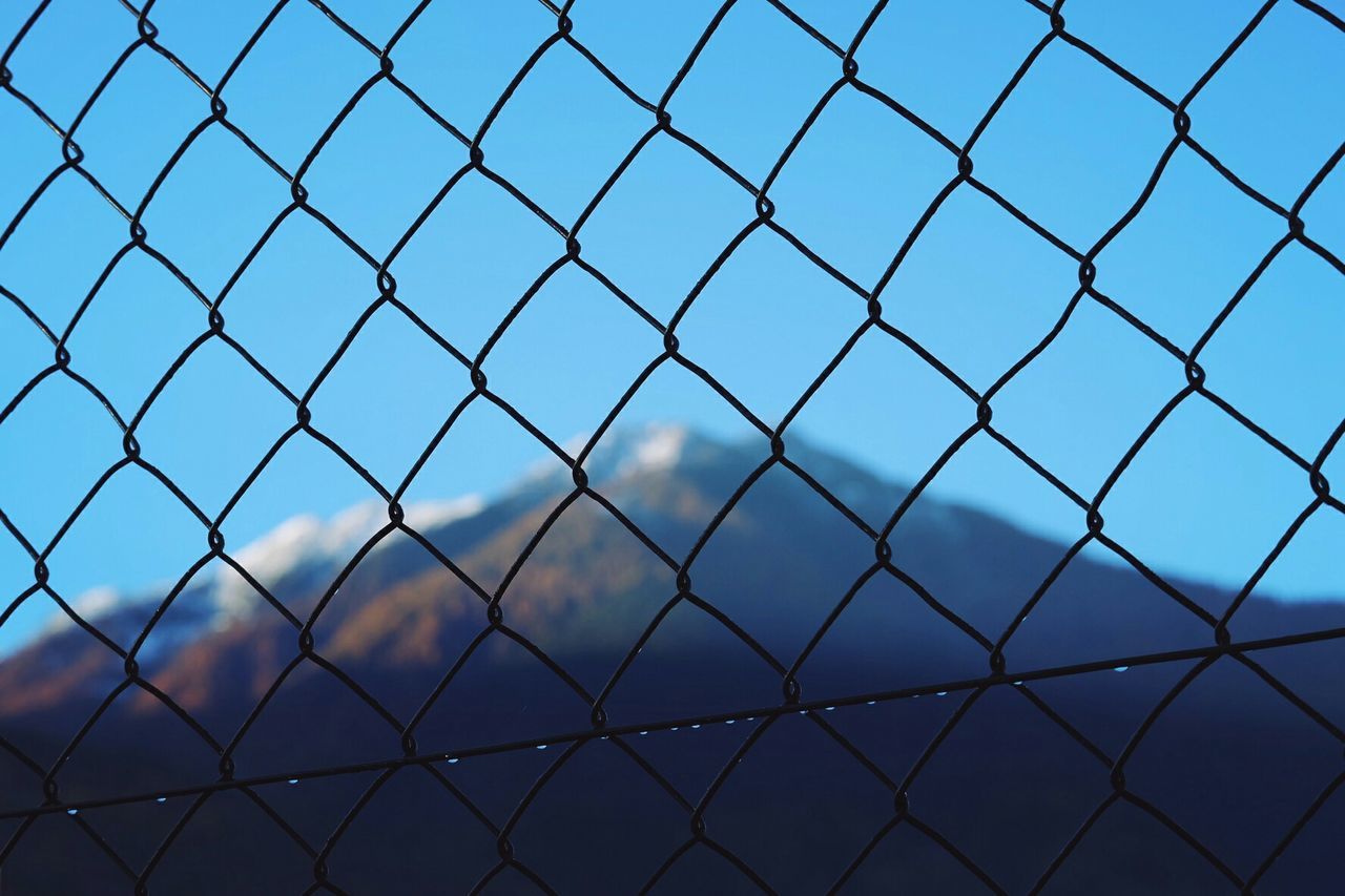 chainlink fence, fence, metal, blue, full frame, protection, sky, safety, pattern, backgrounds, security, metallic, day, close-up, no people, outdoors, sunlight, focus on foreground, cloud, built structure