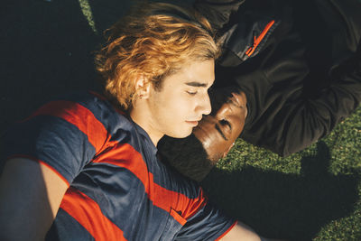 High angle view of friends lying in park