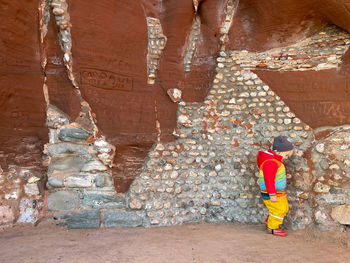 Rear view of man standing on rock