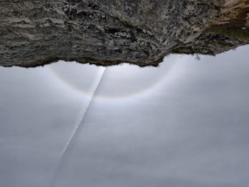 Low angle view of rock formation against sky