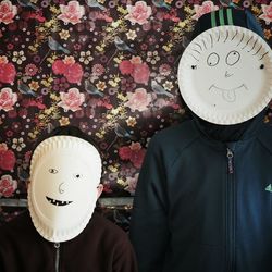 Father with his son making face masks