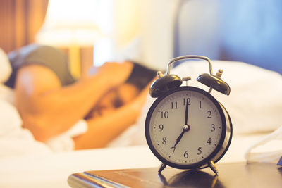 Close-up of man sleeping on bed