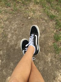 Low section of woman legs on road