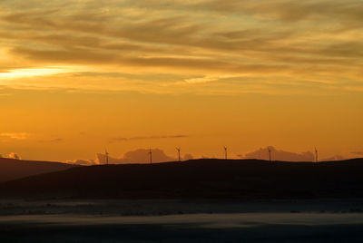 Scenic view of silhouette land against sky during sunset