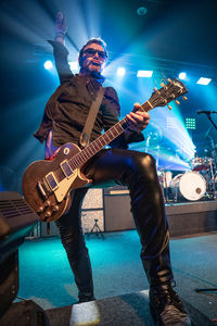 Man playing guitar at music concert