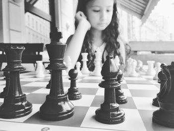 Girl playing chess in balcony