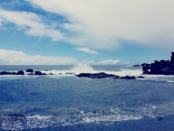 Scenic view of sea against cloudy sky